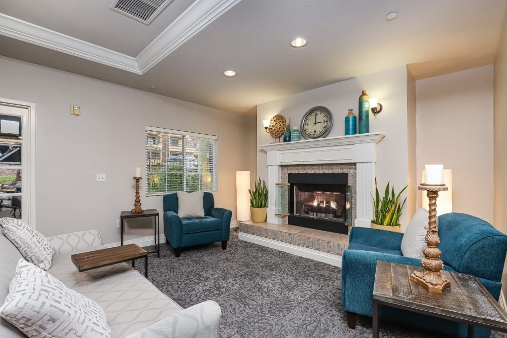 Resident living room with carpeting and cozy fireplace at Pacifica Senior Living Poway in Poway, California