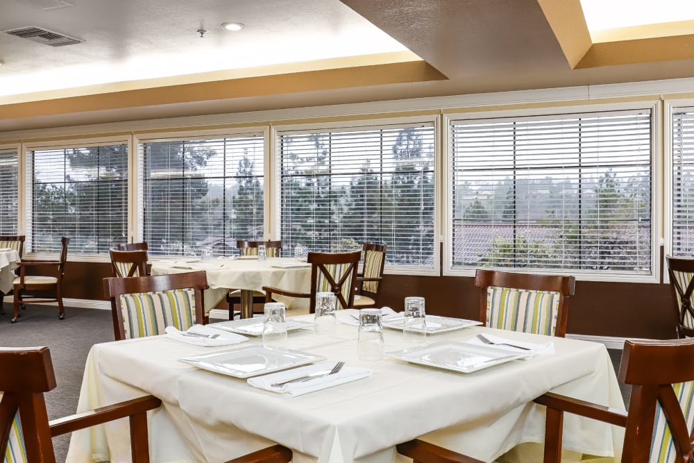 Resident dining room with large windows at Pacifica Senior Living Poway in Poway, California