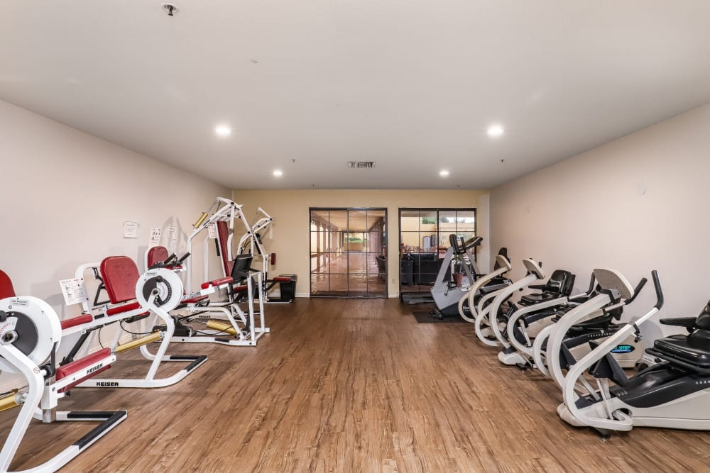 Resident exercise room with various workout equipment at Pacifica Senior Living Poway in Poway, California