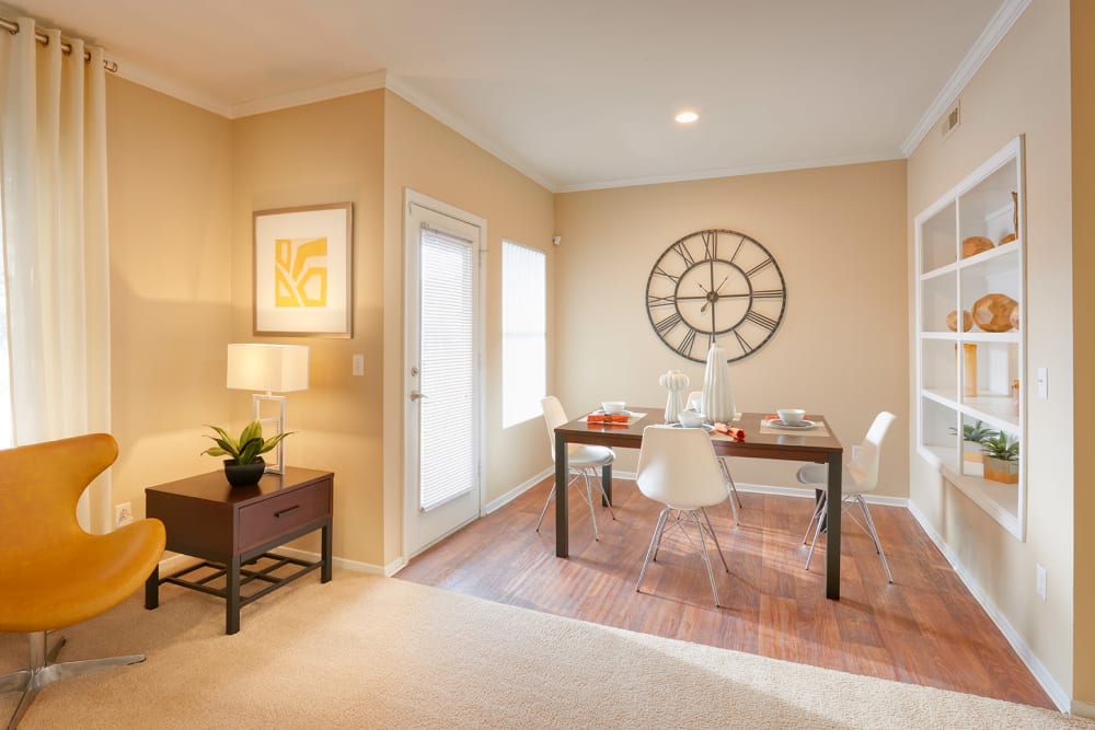 Dining room with wood-style flooring at Legend Oaks Apartments in Aurora, Colorado