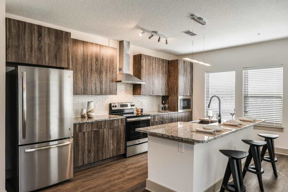 Kitchen apartment with stainless steel appliances and granite counter tops at Soba Apartments in Jacksonville, Florida