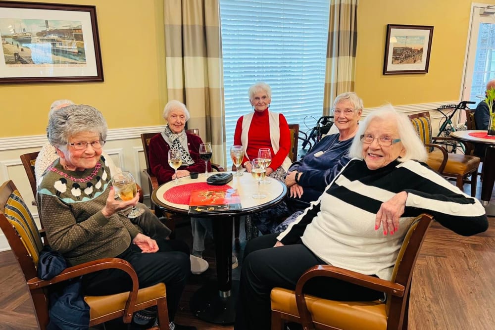 Five residents sitting around a table at Harmony Senior Services