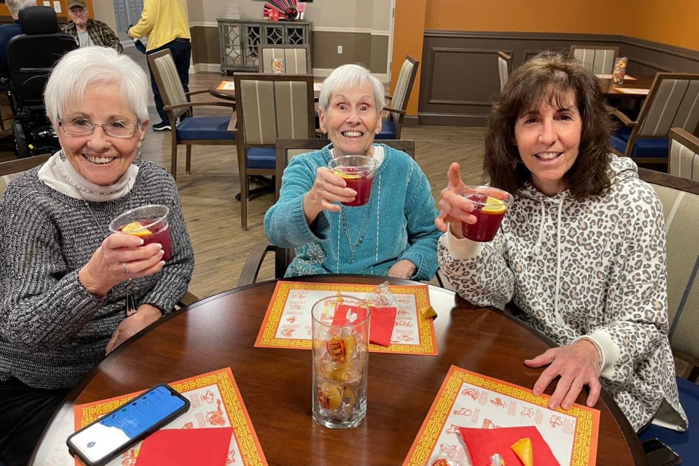 Residents holding drinks at Harmony Senior Services