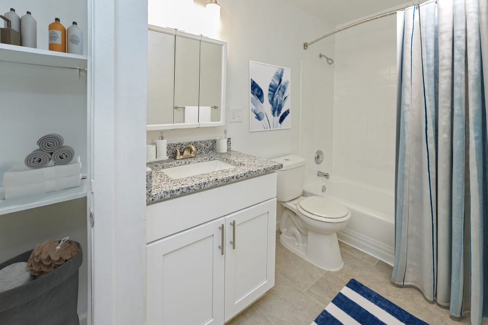 Renovated bathroom with white vanity and granite counter
