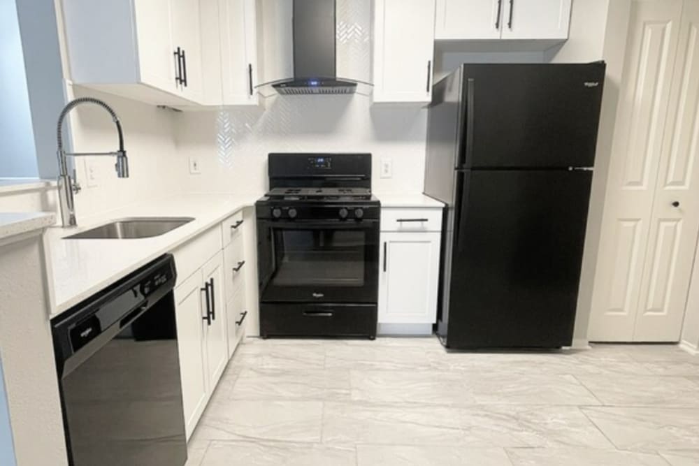 Modern kitchen with black appliances at Artisan at Lawrenceville in Lawrenceville, New Jersey