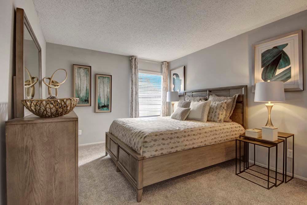 Clean and relaxing bedroom at The Fairway Apartments in Plano, Texas