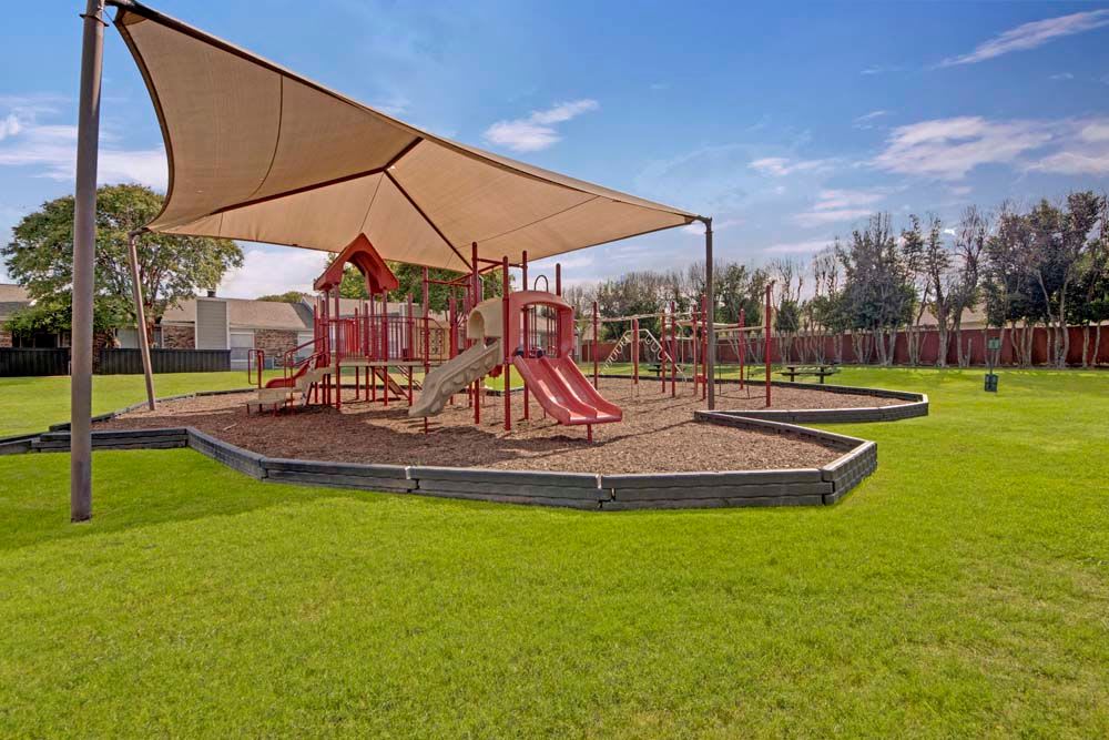 Shaded play area at The Fairway Apartments in Plano, Texas