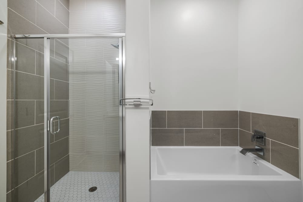 Bathrooms with separate soaking tub and stand-up showers at Marq Music Row in Nashville, Tennessee