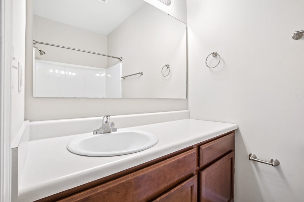 Model bathroom with framed mirror at Olympus at Jack Britt in Fayetteville, North Carolina