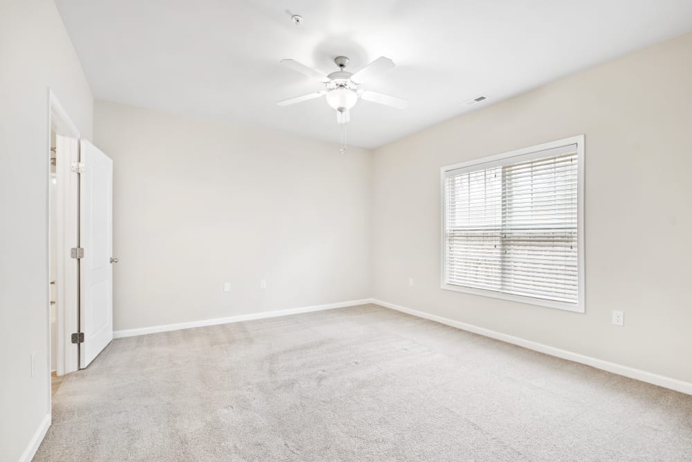 Empty bedroom unit with ceiling fan at Olympus at Jack Britt in Fayetteville, North Carolina