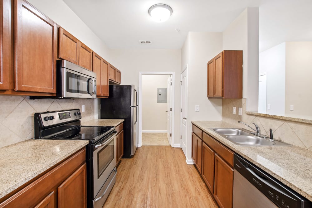 Model kitchen space with wood accents at Olympus at Jack Britt in Fayetteville, North Carolina