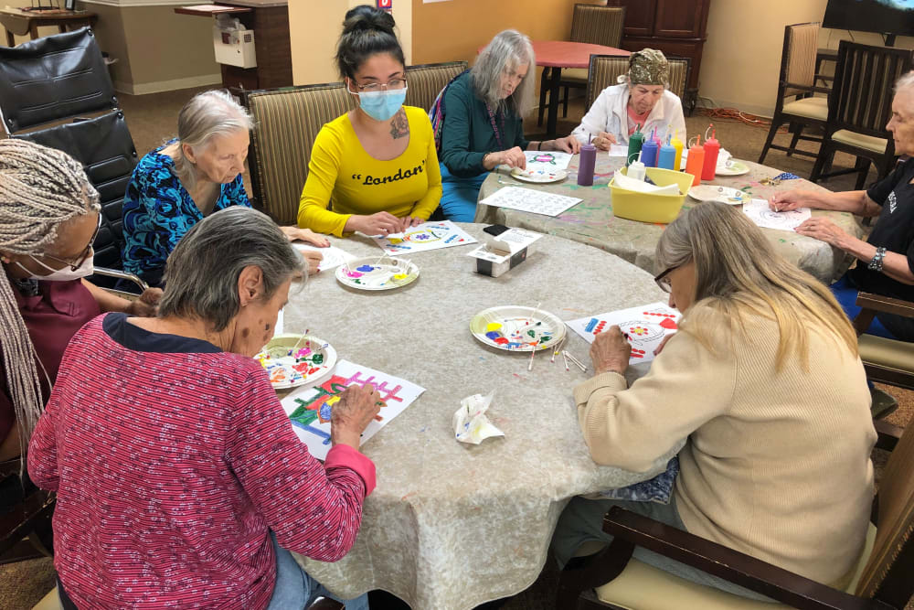 Residents taking a painting class at Shawnee Memory Care in Shawnee, Oklahoma