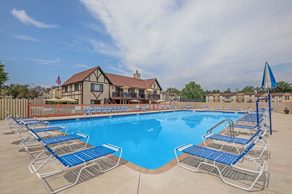 Sparkling pool with lounge chairs and umbrella at The Addison, North Wales, Pennsylvania