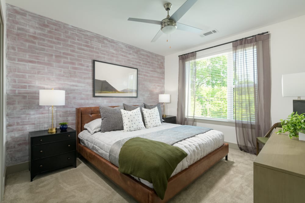 Model bedroom with green accents at Quill in Atlanta, Georgia