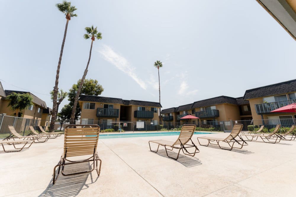 Pool seating at Casa La Palma Apartment Homes in La Palma, California