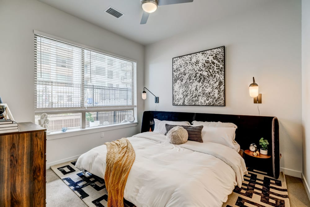 Model bedroom with large window at Vue West Apartment Homes in Denver, Colorado