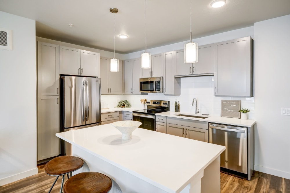 Kitchen with chef's island and quartz countertops at Vue West Apartment Homes in Denver, Colorado