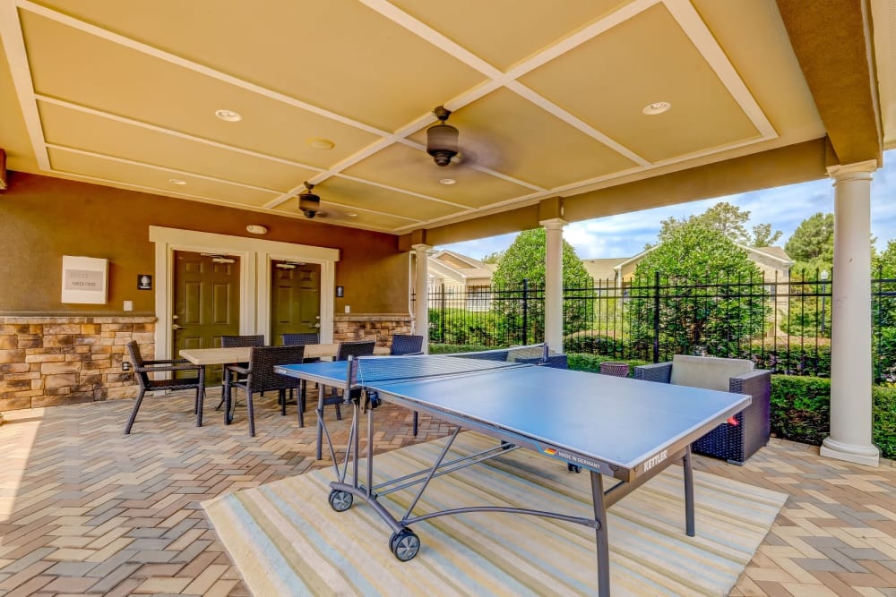 Outdoor resident patio with ping pong table at Estates at McDonough Apartment Homes in McDonough, Georgia