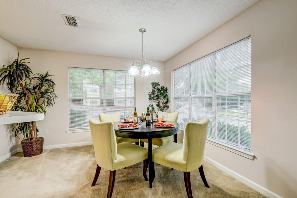 Well lit dining room with a gorgeous window view located at Keswick Village Apartments & Townhomes in Conyers, Georgia