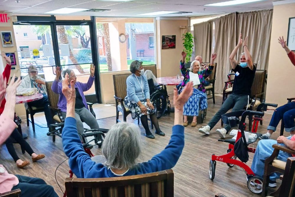 Team exercise with residents at Woodland Palms Memory Care in Tucson, Arizona
