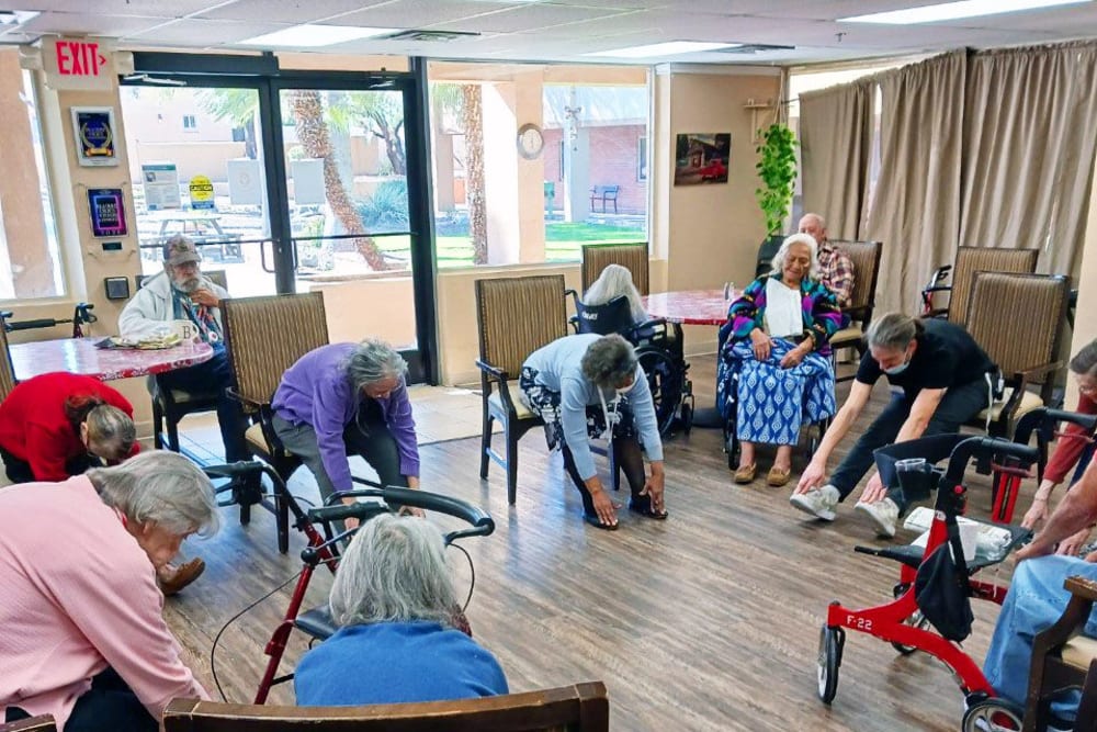 Exercise with residents at Woodland Palms Memory Care in Tucson, Arizona
