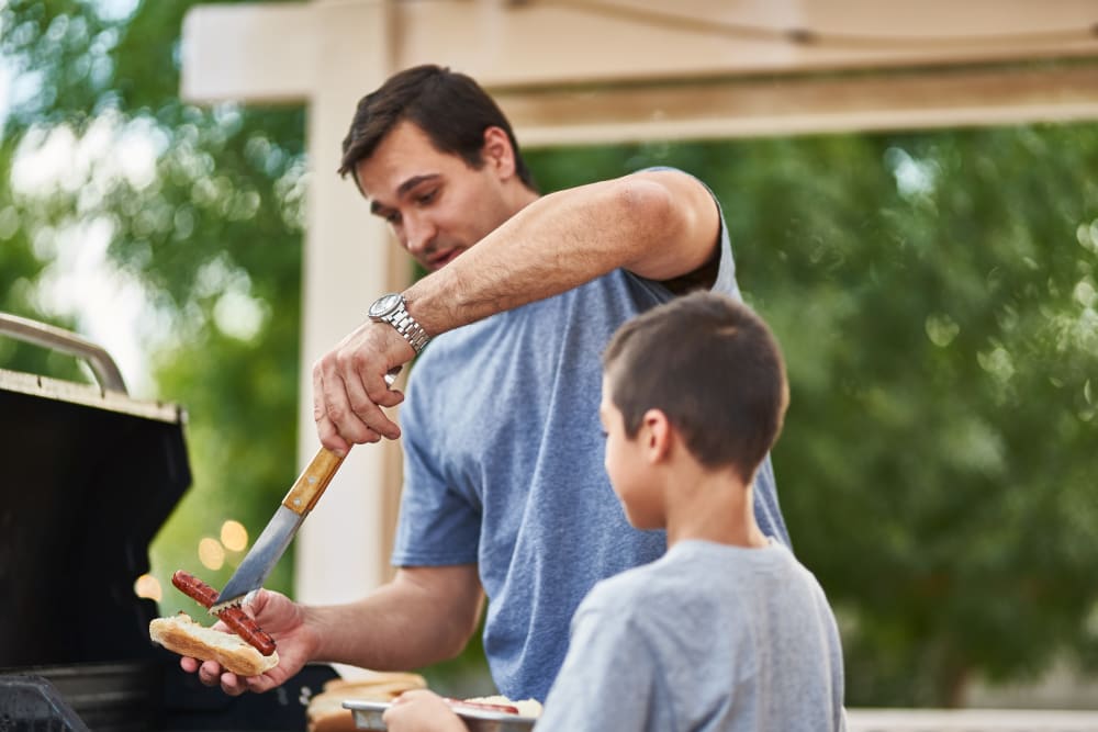 Dad and son grilling at  The Everstead at Windrose in Spring, Texas