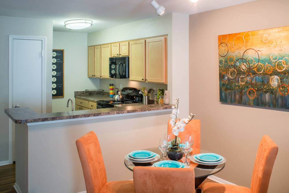Dining table connected to kitchen at The Elms at Falls Run in Ellicott City, Maryland