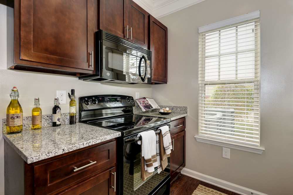 Kitchen with black appliances at The Elms at Odenton in Odenton, Maryland