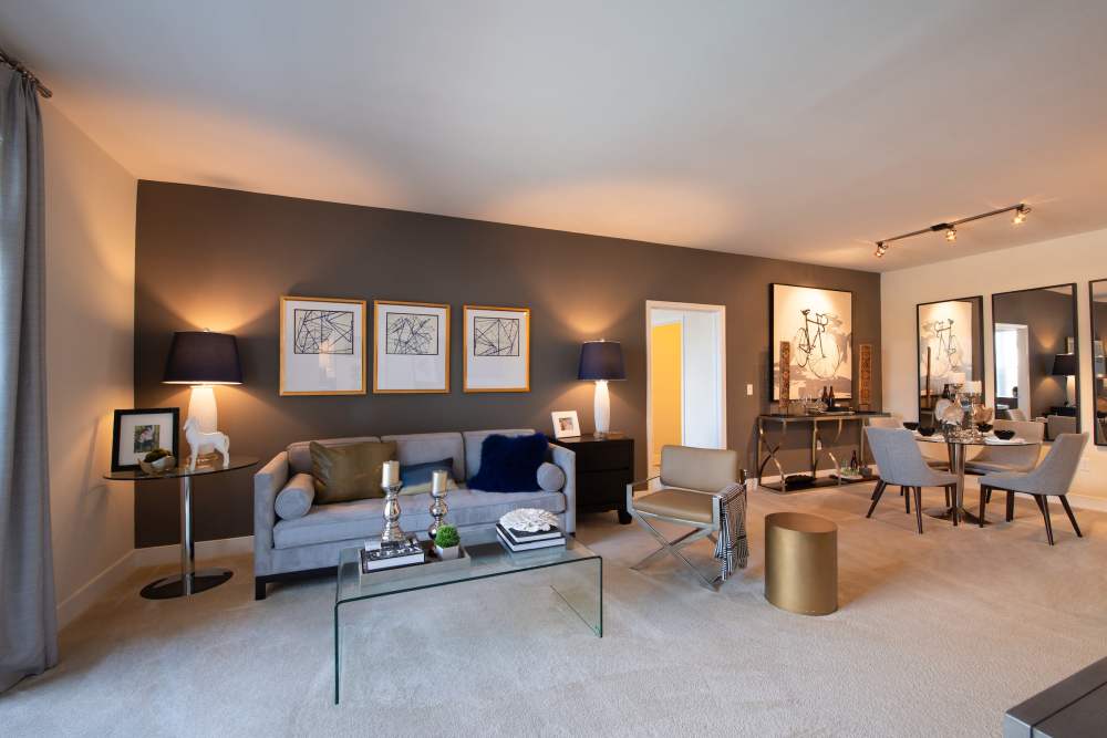 Spacious living room with attached dining at The Elms at Shannon's Glen in Jessup, Maryland