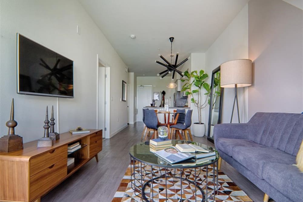 Model living room with a celing fan at Angelene Apartments in West Hollywood, California