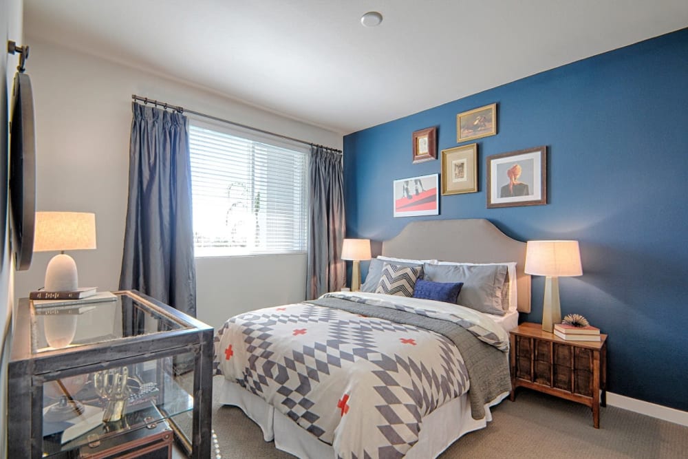 Model living room with blue walls at Angelene Apartments in West Hollywood, California