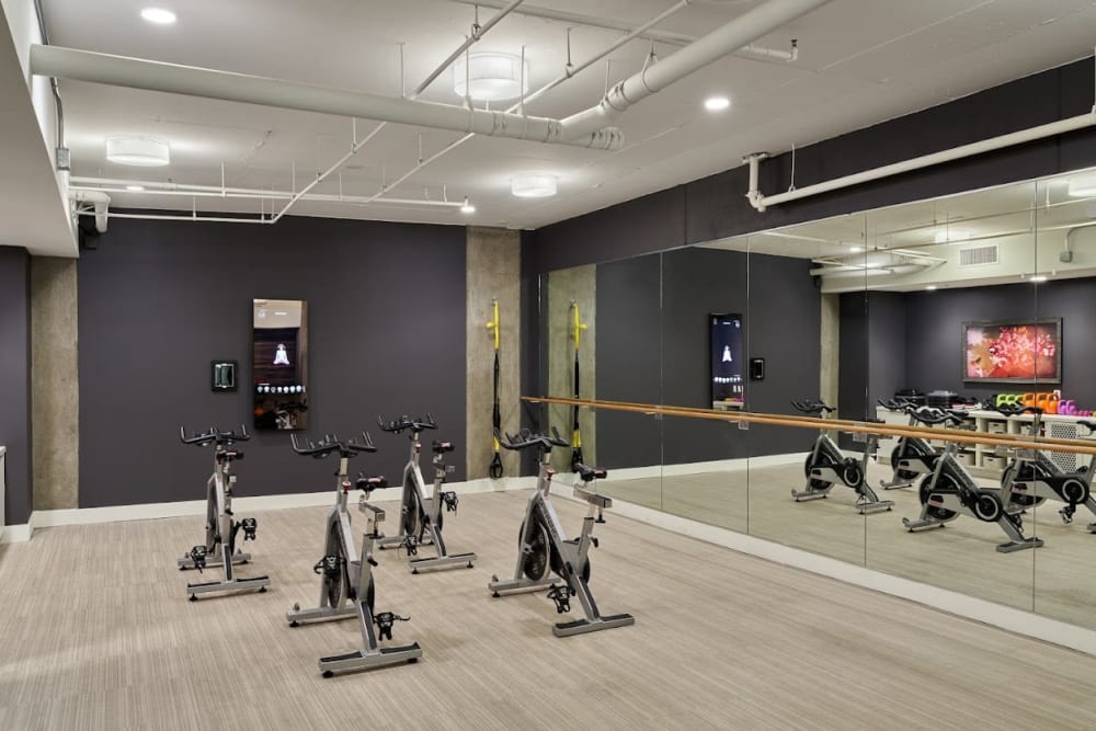 Exercise room with bikes at Angelene Apartments in West Hollywood, California