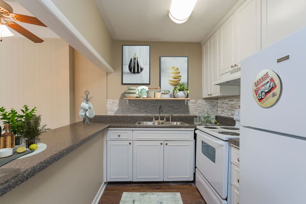 Kitchen with bar at Belmont Place Apartments in Nashville, Tennessee