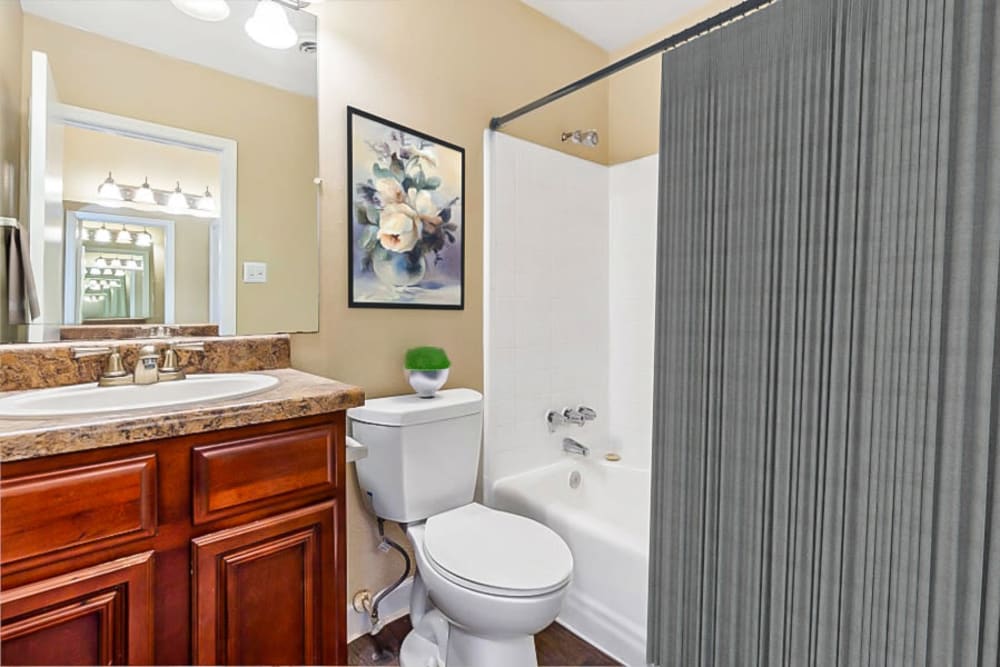 Bathroom with granite countertops at The Crossing at Henderson Mill Apartment Homes in Atlanta, Georgia
