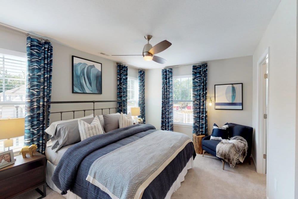 Bedroom with large windows and modern details at Dragas Home Rentals in Virginia Beach, Virginia