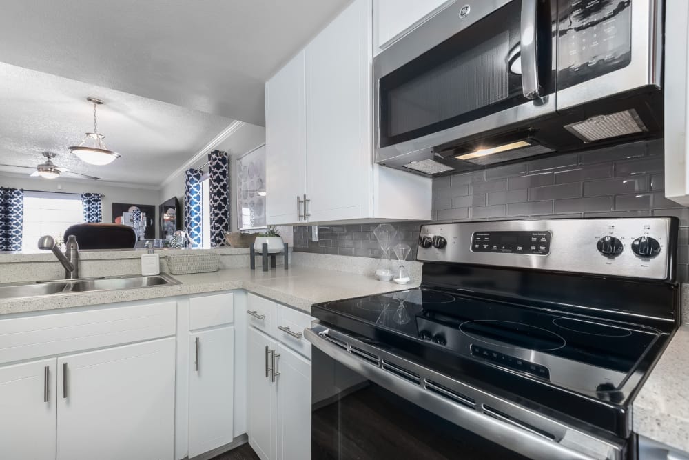 Kitchen with stainless steel appliances and white cabinets at Barrington Place at Winter Haven in Winter Haven, Florida