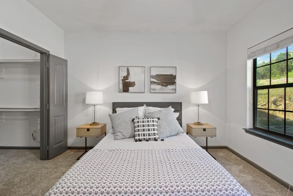 Model bedroom with two nightstands and lamps at Marquis on Evans in San Antonio, Texas