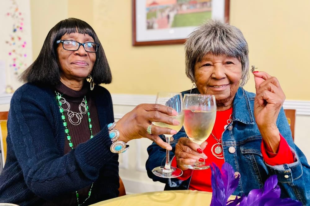 Two residents cheersing at Harmony Senior Services