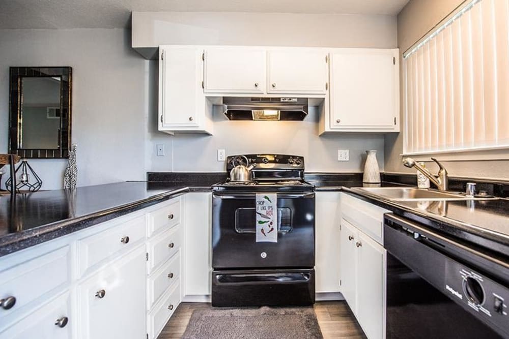 Kitchen with black appliances at The Eleven Hundred in Sacramento, California