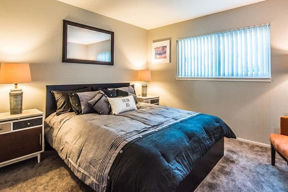 Model bedroom with large window at The Eleven Hundred in Sacramento, California