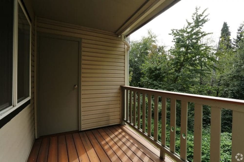 Balcony with a view of the trees at Madison Park Apartments in Bothell, Washington