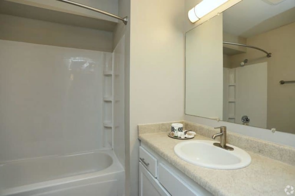 Bathroom with solid countertop at Madison Park Apartments in Bothell, Washington