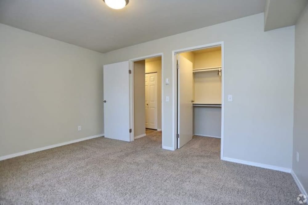 Bedroom with closets at Madison Park Apartments in Bothell, Washington