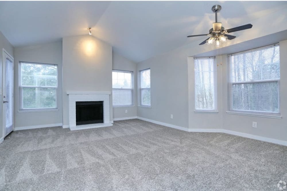 Large living room with ceiling fan at Madison Park Apartments in Bothell, Washington