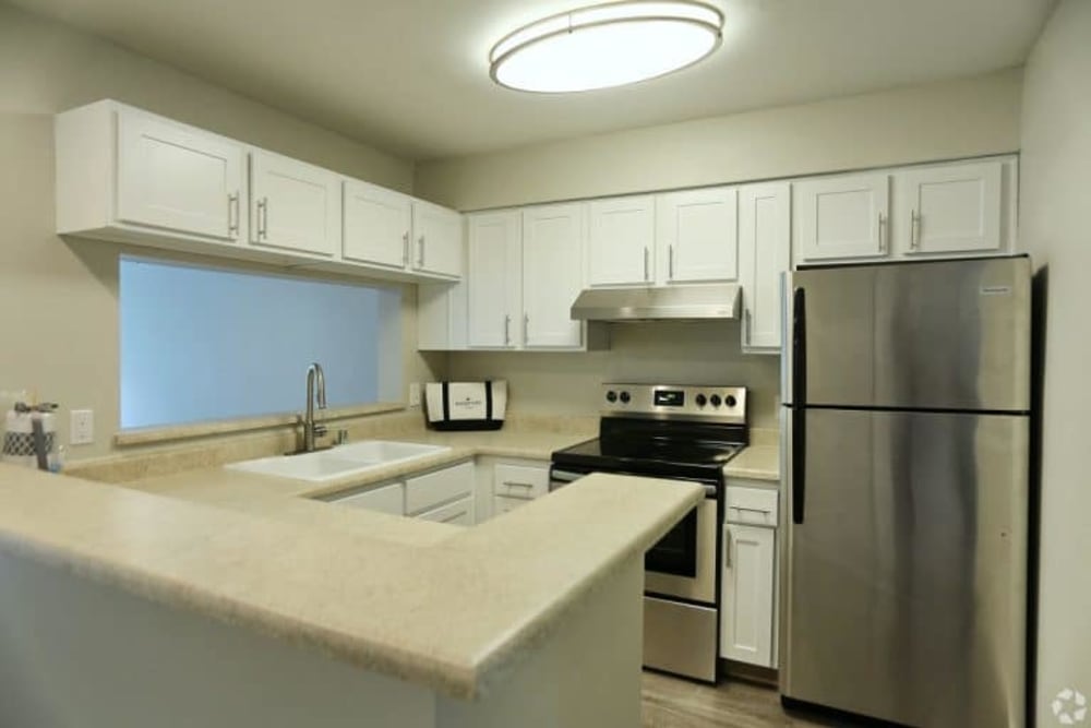 Kitchen with stainless steel appliances at Madison Park Apartments in Bothell, Washington