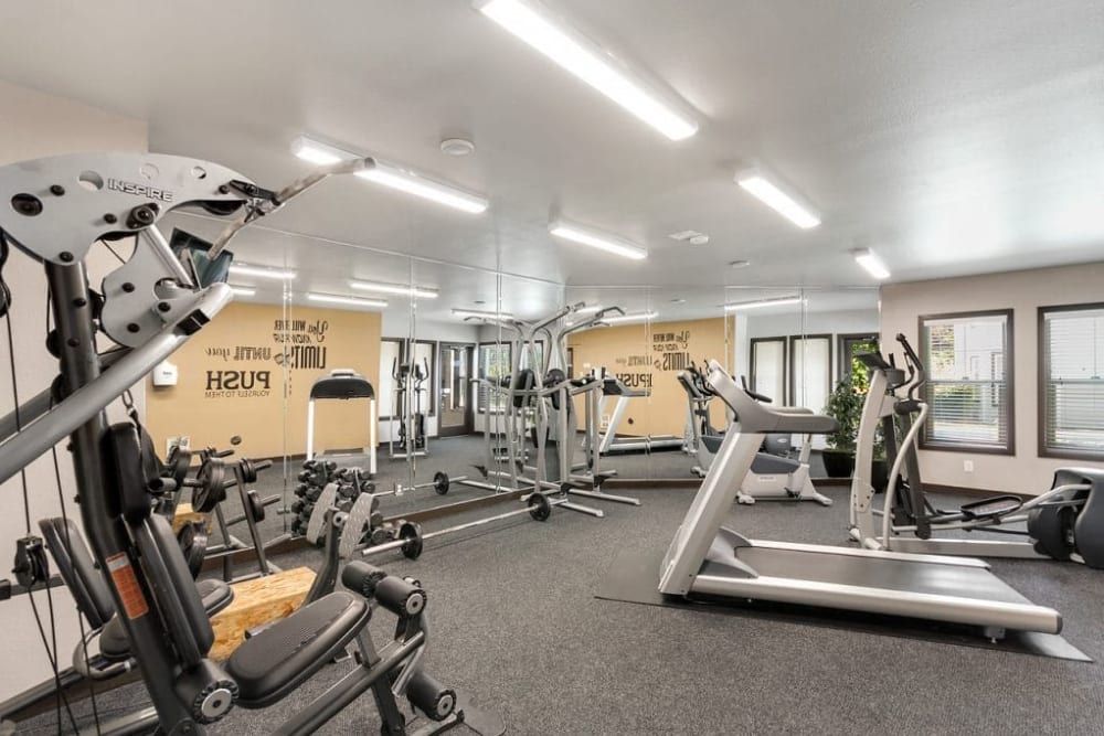 Fitness center with machines at Madison Park Apartments in Bothell, Washington