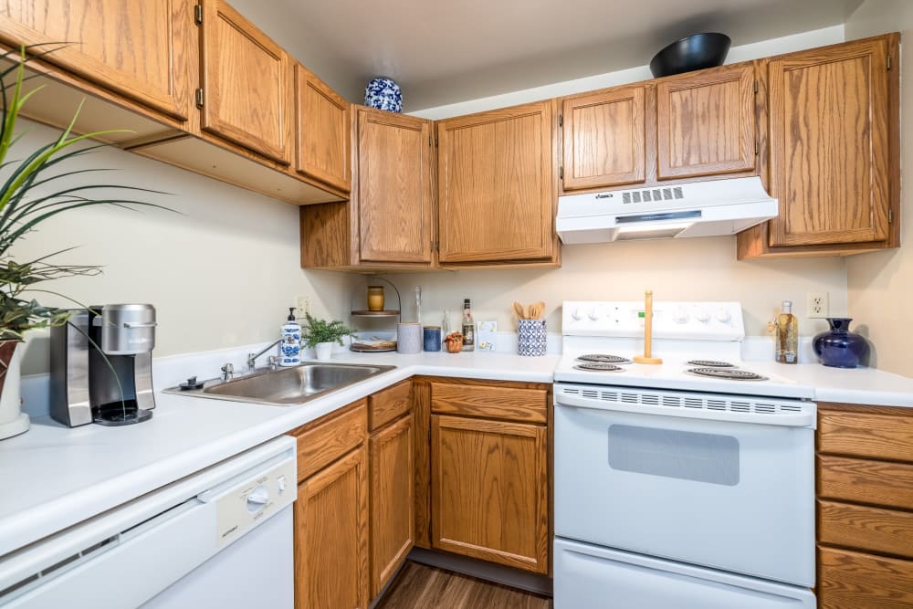 Beautiful modern kitchen with white appliances at Maiden Bridge & Canongate Apartments in Pittsburgh, Pennsylvania