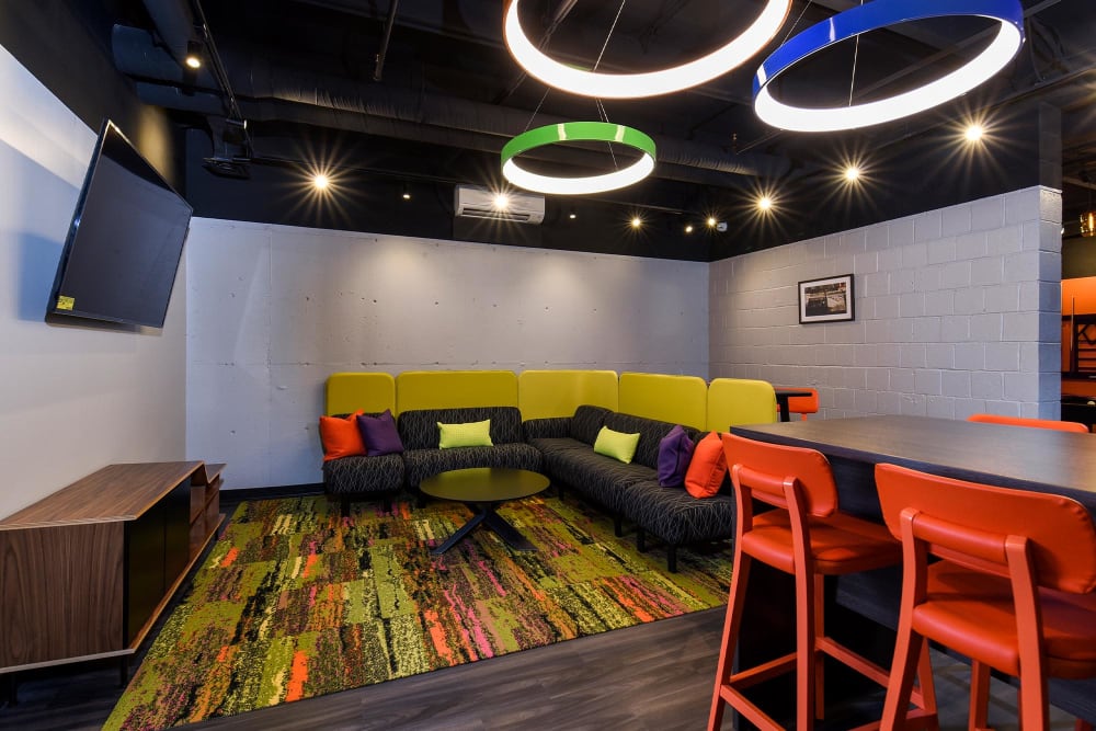 Resident lounge area with a large sofa and flatscreen TV at Landmark Glenmont Station in Silver Spring, Maryland