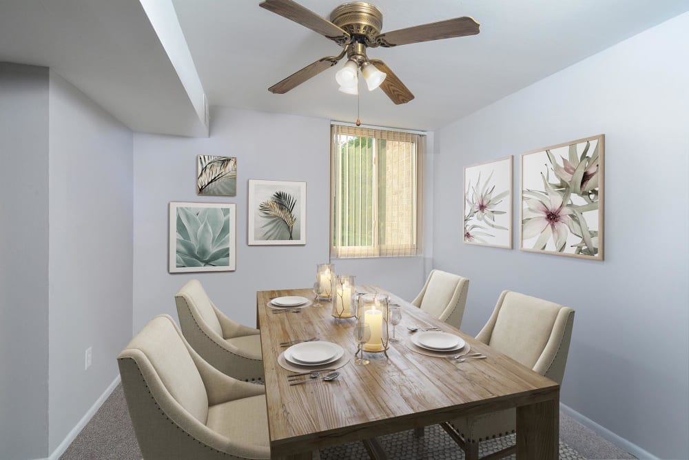 Dining room with a ceiling fan at Landmark Glenmont Station in Silver Spring, Maryland