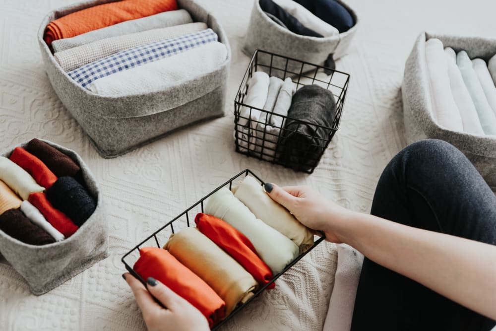 Resident folding clean laundry from the onsite laundry facilities at Westover Pointe in Wilmington, Delaware